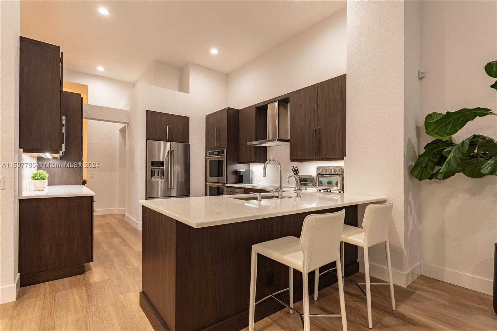 1655 Victoria Pointe Circle Weston, FL 33327 - Photo 15 of 43 a kitchen with stainless steel appliances kitchen island granite countertop a sink refrigerator and cabinets