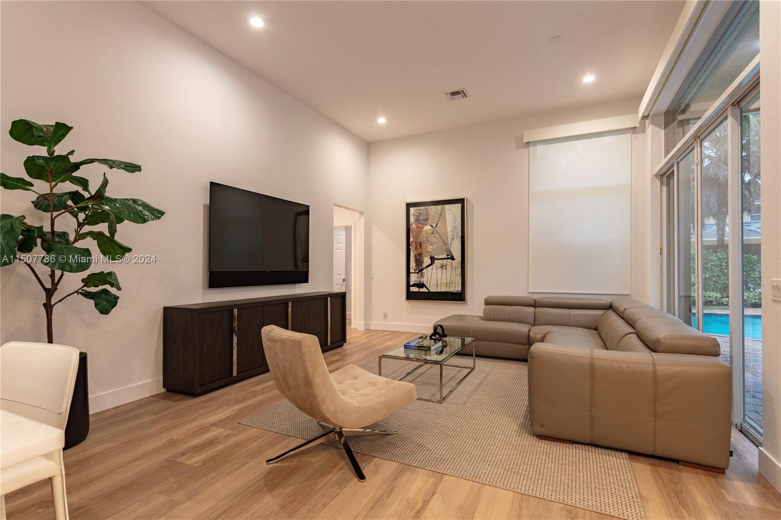 1655 Victoria Pointe Circle Weston, FL 33327 - Photo 16 of 43 a living room with furniture and a flat screen tv