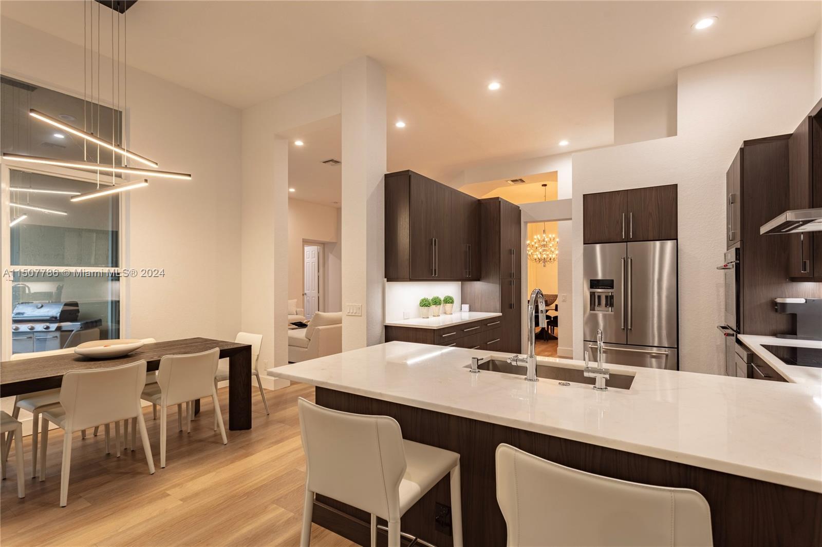 1655 Victoria Pointe Circle Weston, FL 33327 - Photo 17 of 43 a kitchen with stainless steel appliances kitchen island granite countertop a sink and cabinets