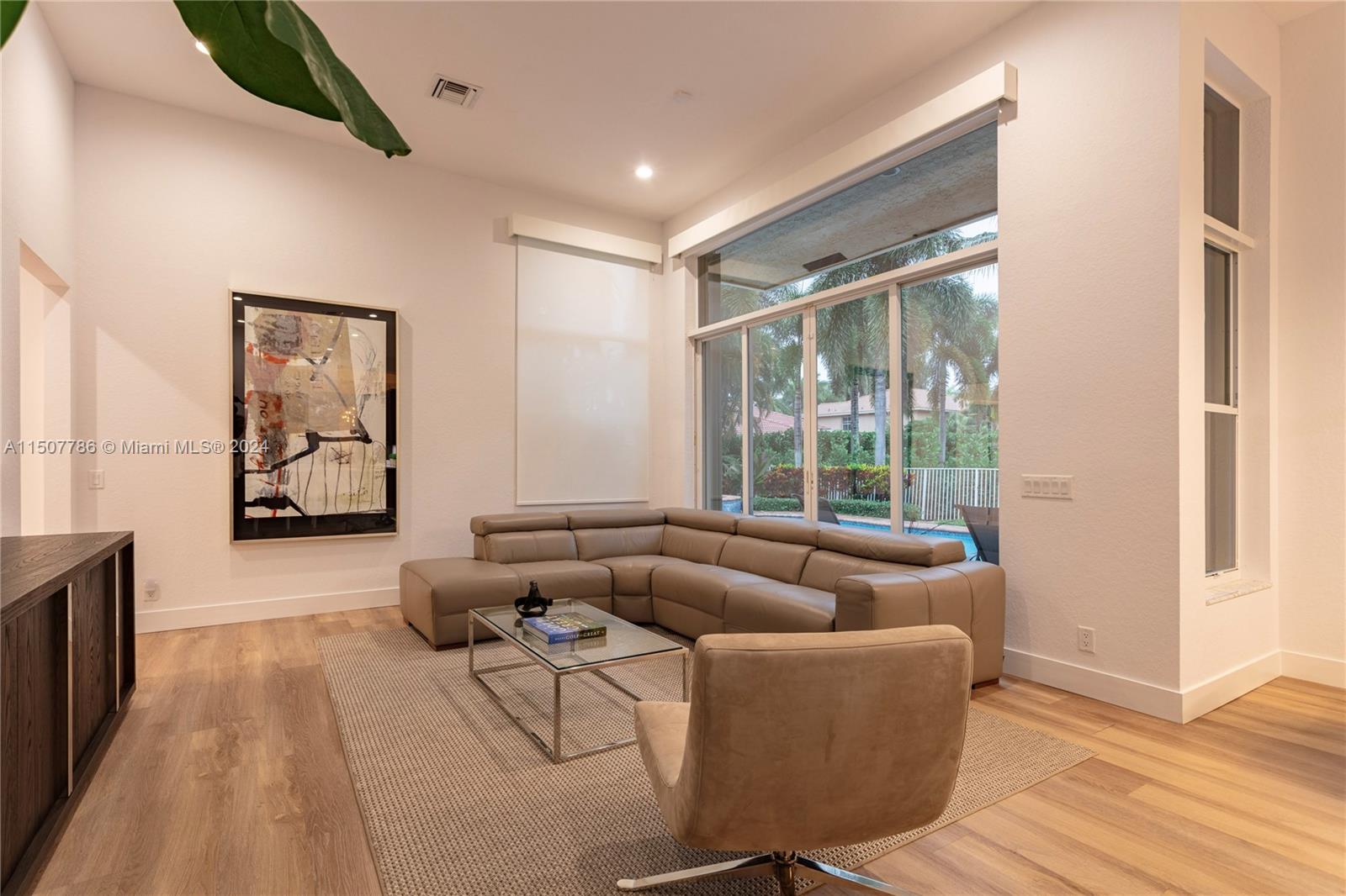 1655 Victoria Pointe Circle Weston, FL 33327 - Photo 18 of 43 a living room with furniture and a large window
