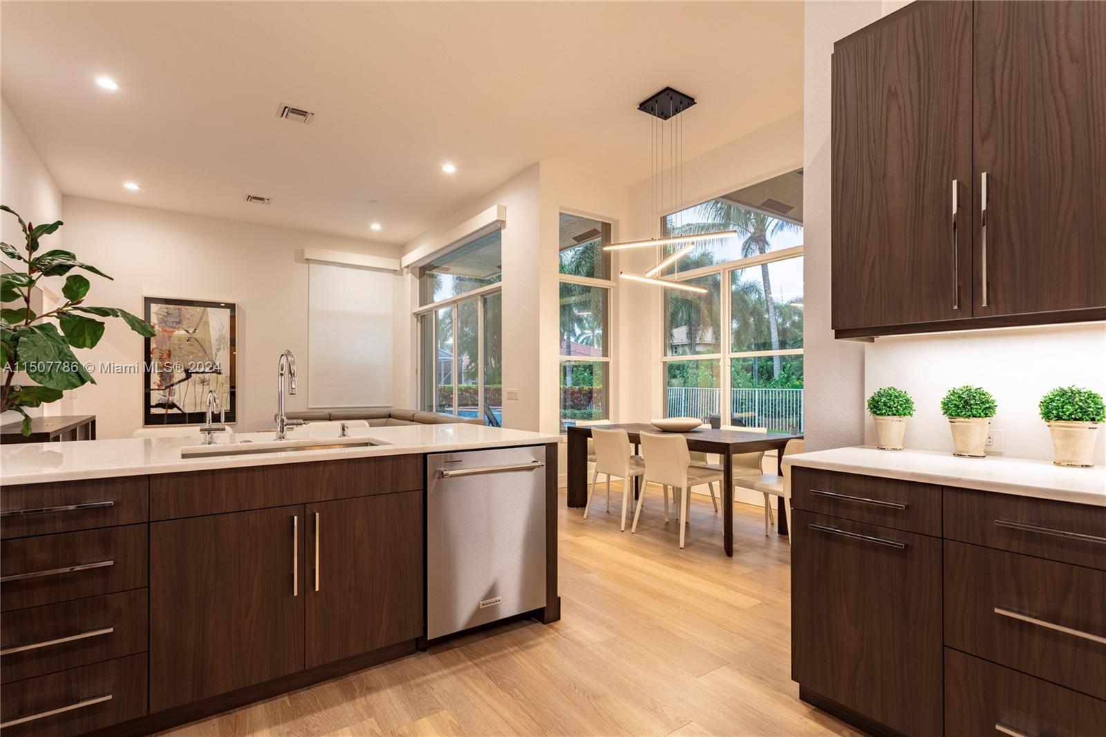1655 Victoria Pointe Circle Weston, FL 33327 - Photo 19 of 43 a kitchen with a sink stove and wooden cabinets
