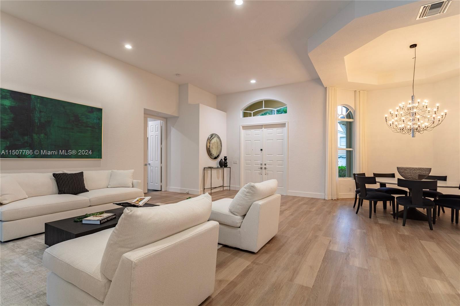 1655 Victoria Pointe Circle Weston, FL 33327 - Photo 20 of 43 a living room with furniture a dining table and a flat screen tv