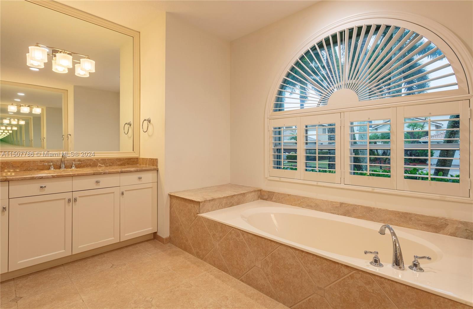 1655 Victoria Pointe Circle Weston, FL 33327 - Photo 23 of 43 a bathroom with a bathtub sink and mirror