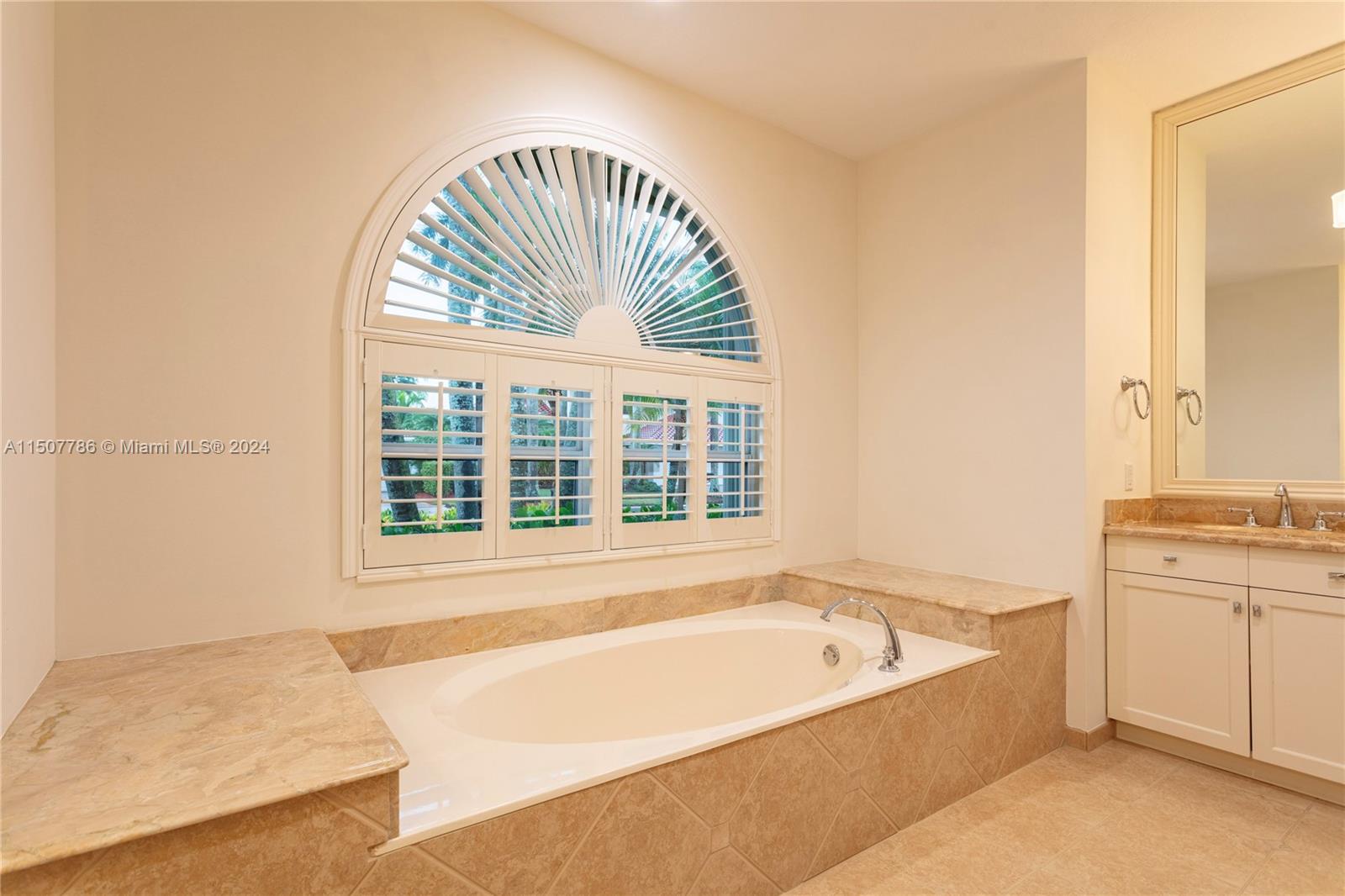 1655 Victoria Pointe Circle Weston, FL 33327 - Photo 24 of 43 a spacious bathroom with a tub and a large window