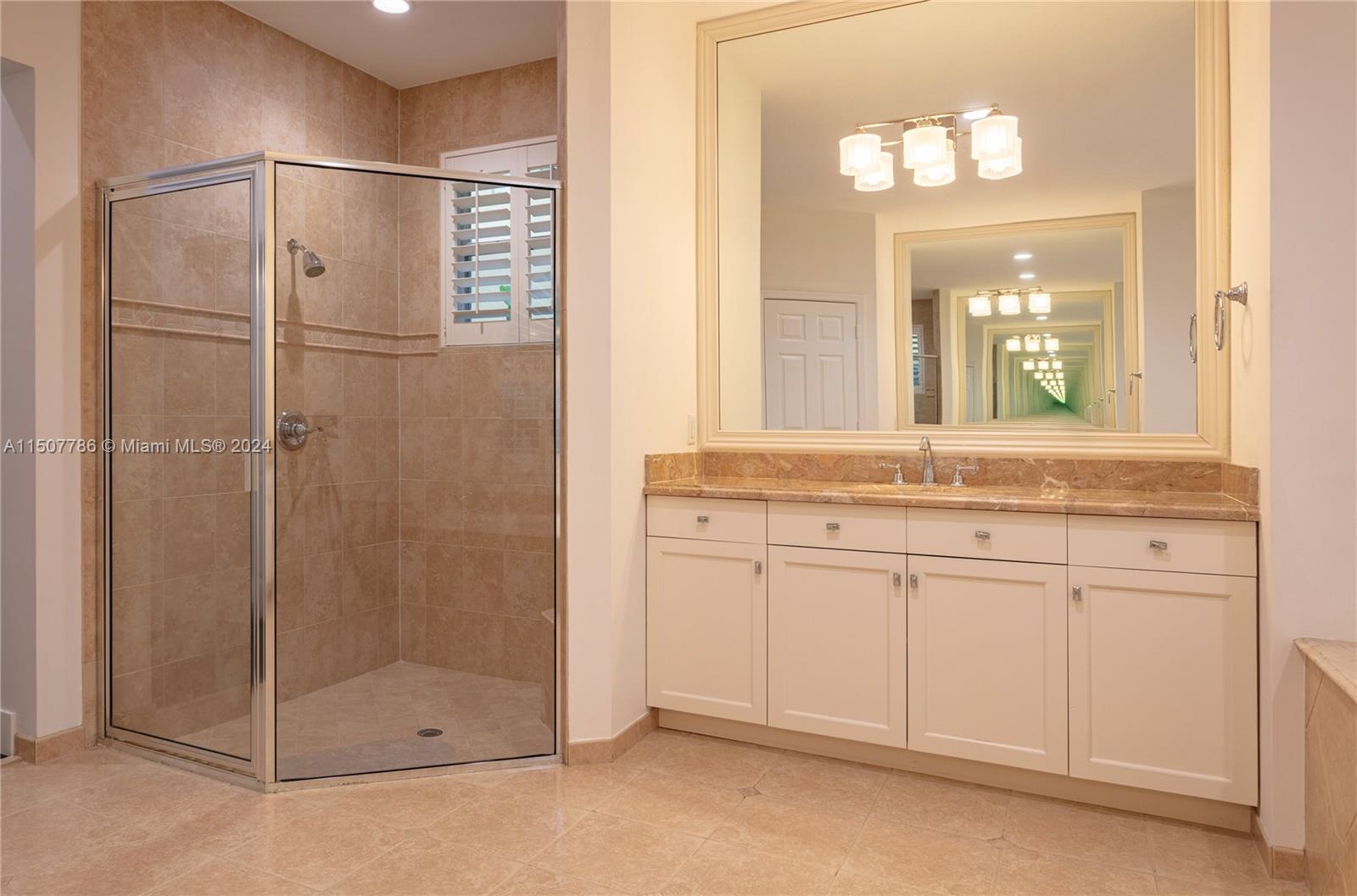 1655 Victoria Pointe Circle Weston, FL 33327 - Photo 25 of 43 a bathroom with a granite countertop sink a mirror and a shower