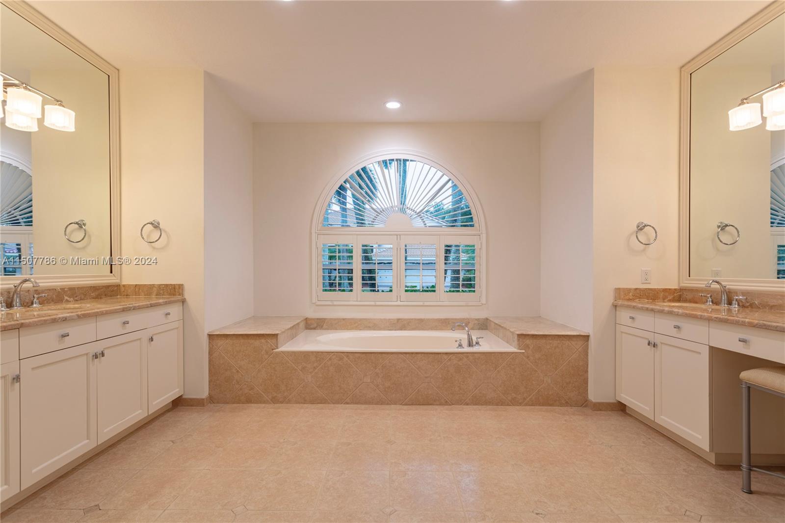 1655 Victoria Pointe Circle Weston, FL 33327 - Photo 26 of 43 a bathroom with a granite countertop bathtub a sink and a large window