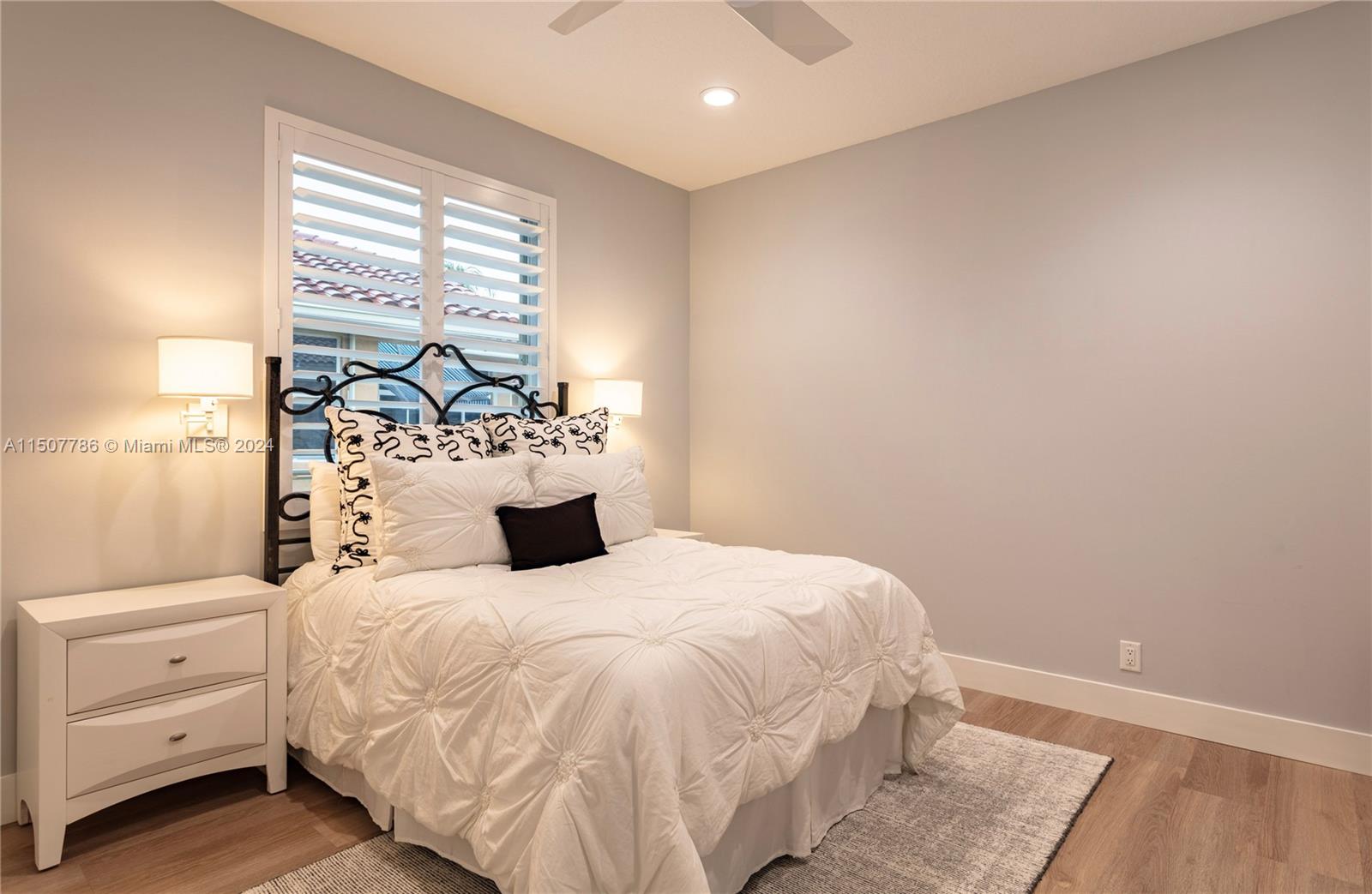 1655 Victoria Pointe Circle Weston, FL 33327 - Photo 31 of 43 a bedroom with a large bed and a window