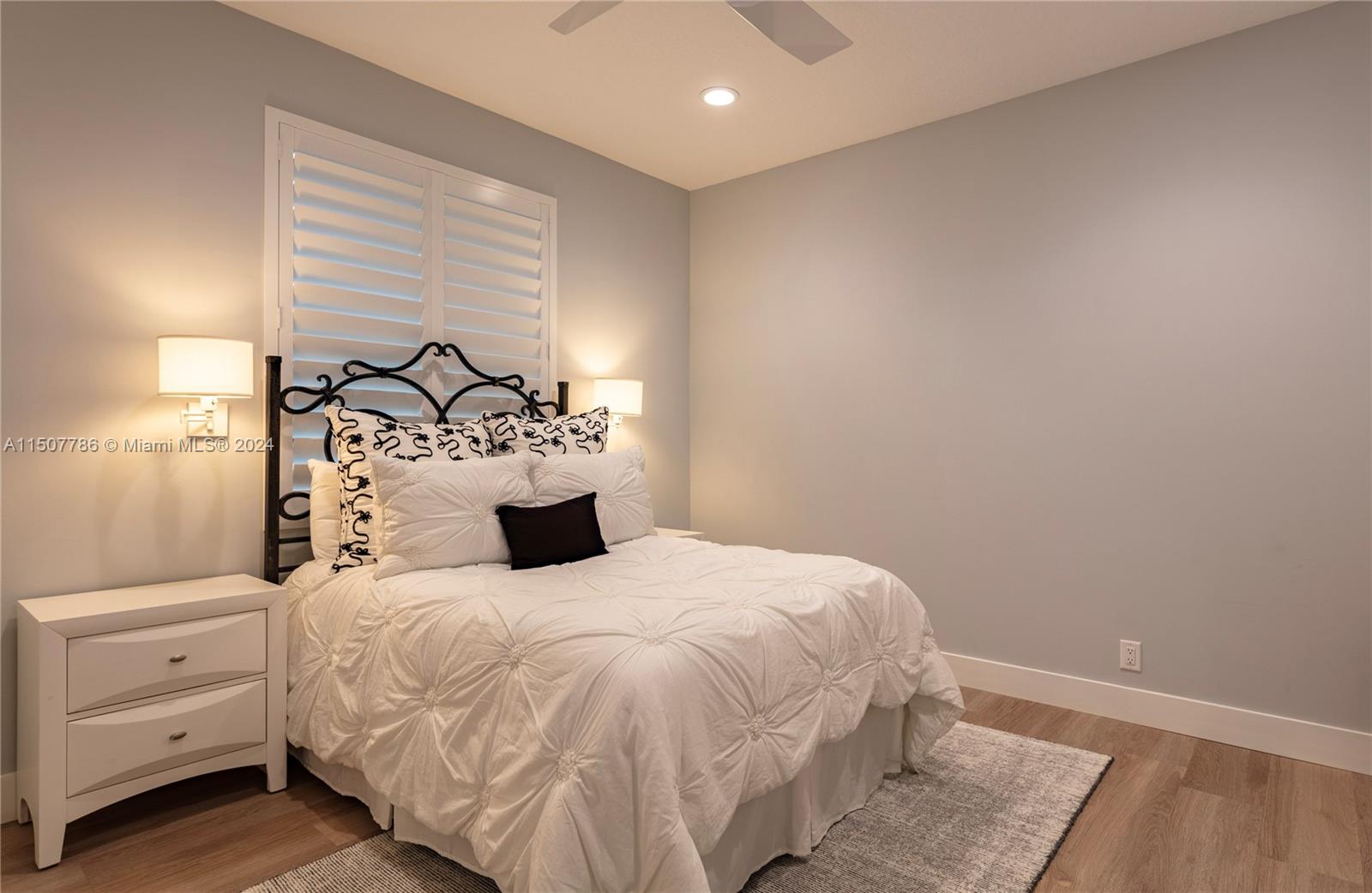 1655 Victoria Pointe Circle Weston, FL 33327 - Photo 32 of 43 a bedroom with a large bed and a window