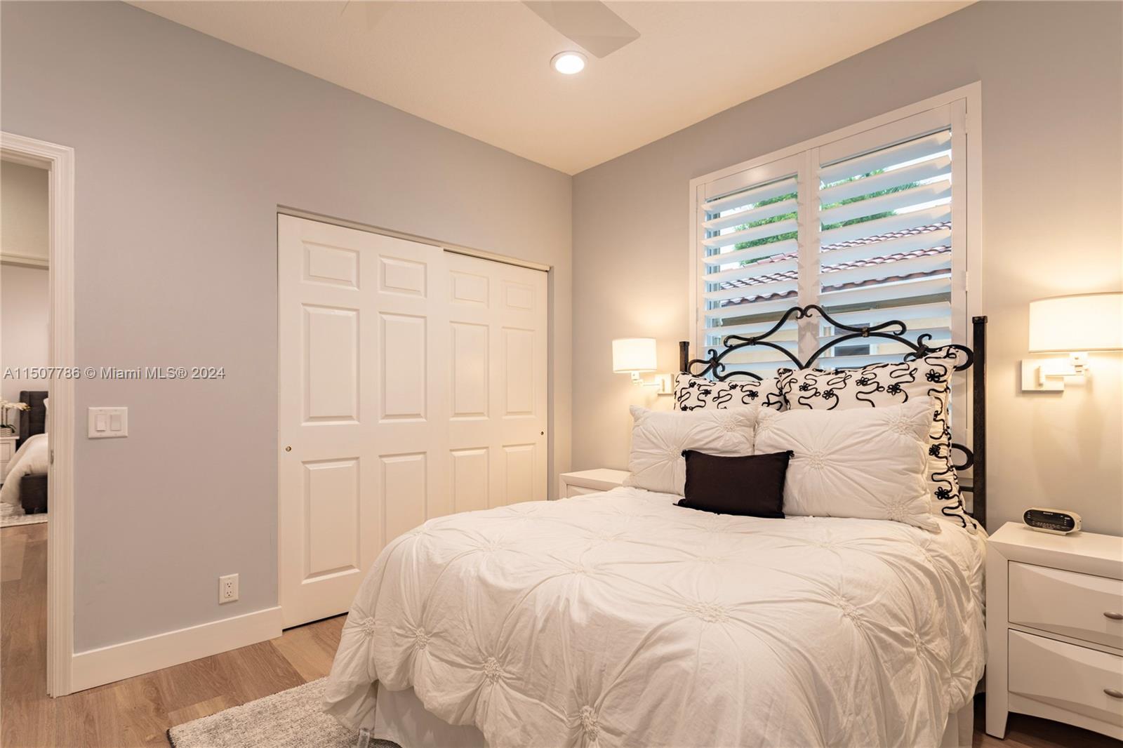 1655 Victoria Pointe Circle Weston, FL 33327 - Photo 33 of 43 a bedroom with a large bed and a window