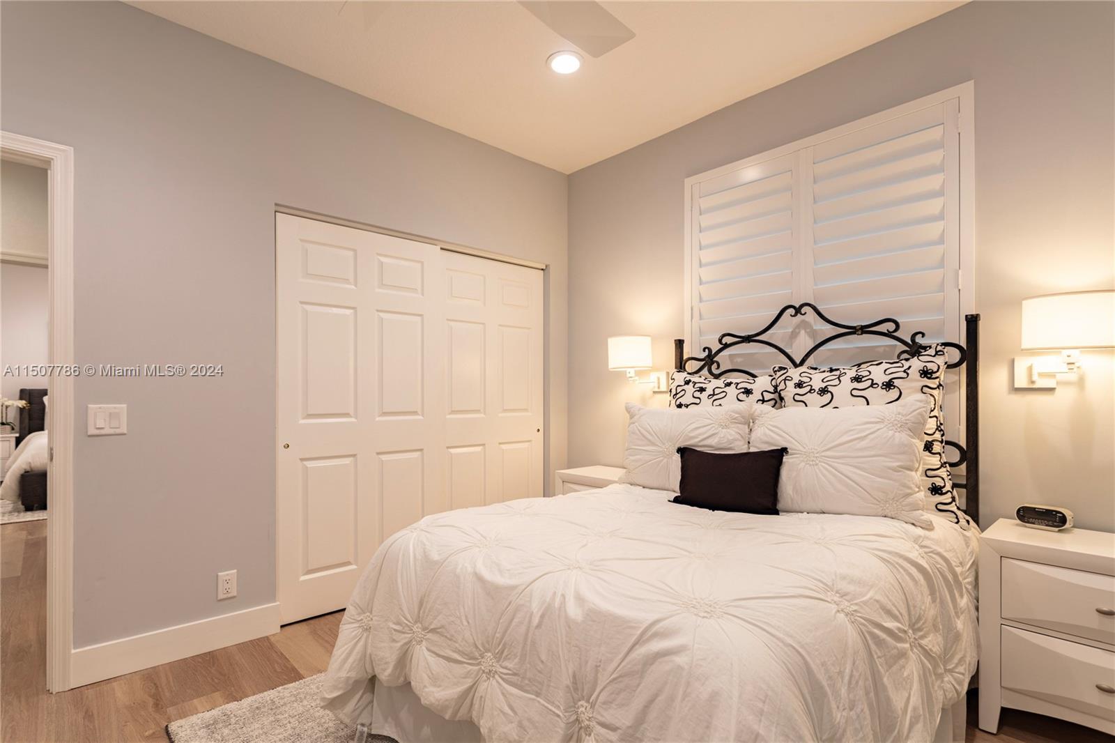 1655 Victoria Pointe Circle Weston, FL 33327 - Photo 34 of 43 a bedroom with a bed and a chandelier