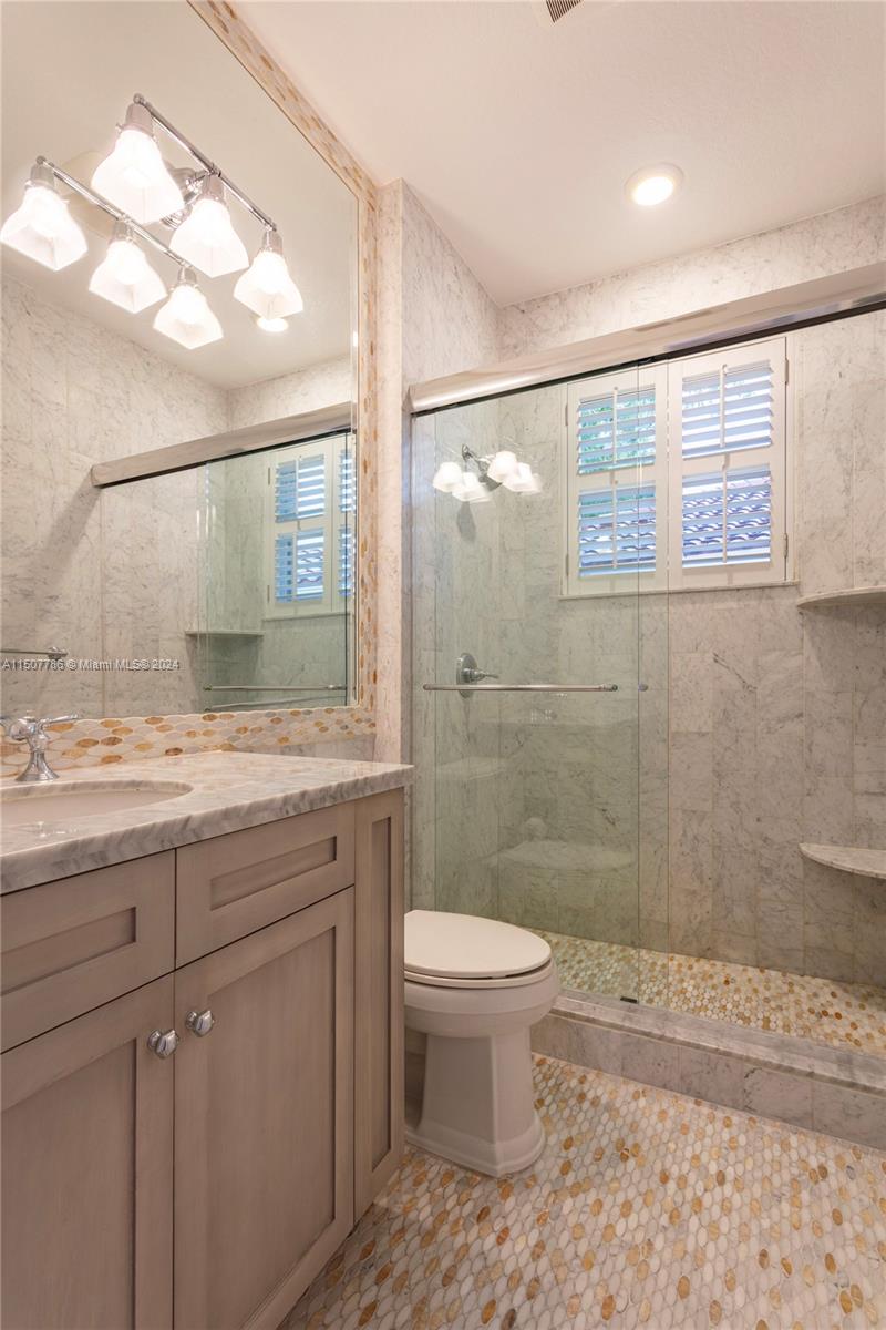 1655 Victoria Pointe Circle Weston, FL 33327 - Photo 35 of 43 a bathroom with a sink a toilet and shower