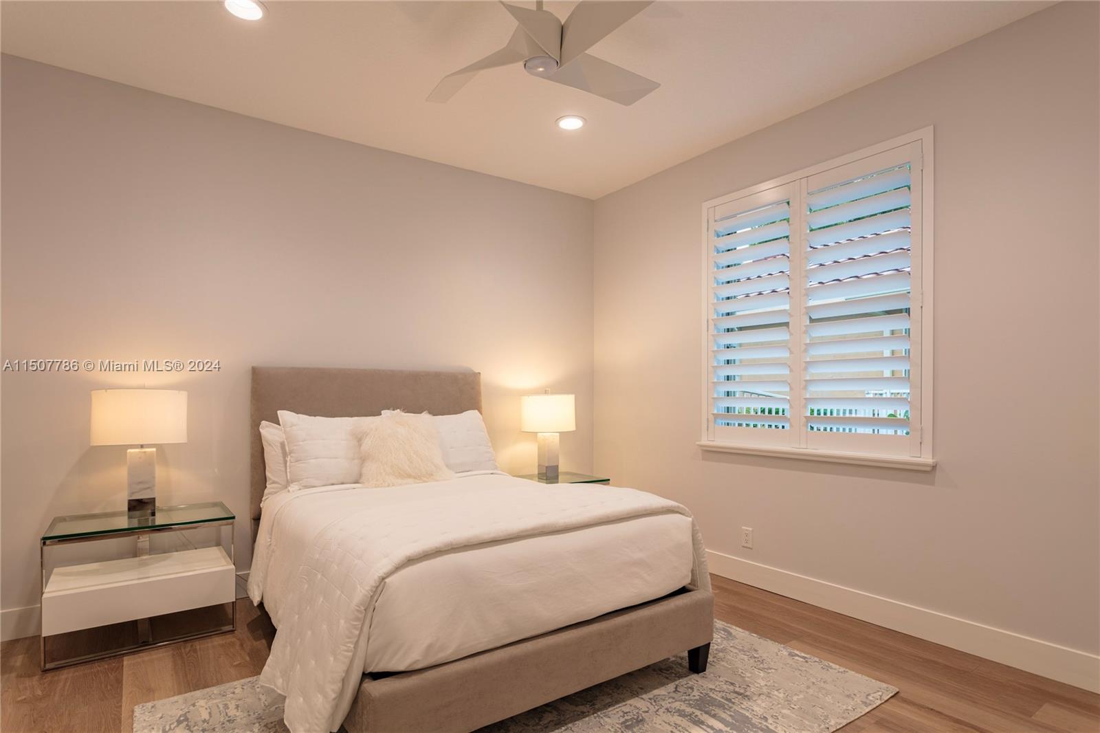 1655 Victoria Pointe Circle Weston, FL 33327 - Photo 36 of 43 a bedroom with a bed and a night stand