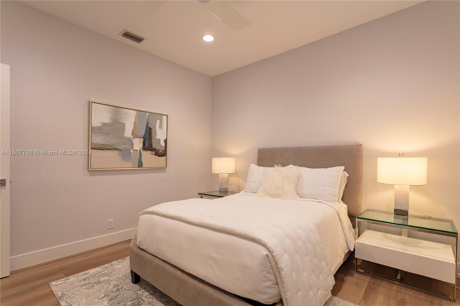 1655 Victoria Pointe Circle Weston, FL 33327 - Photo 37 of 43 a bedroom with a bed and a lamp