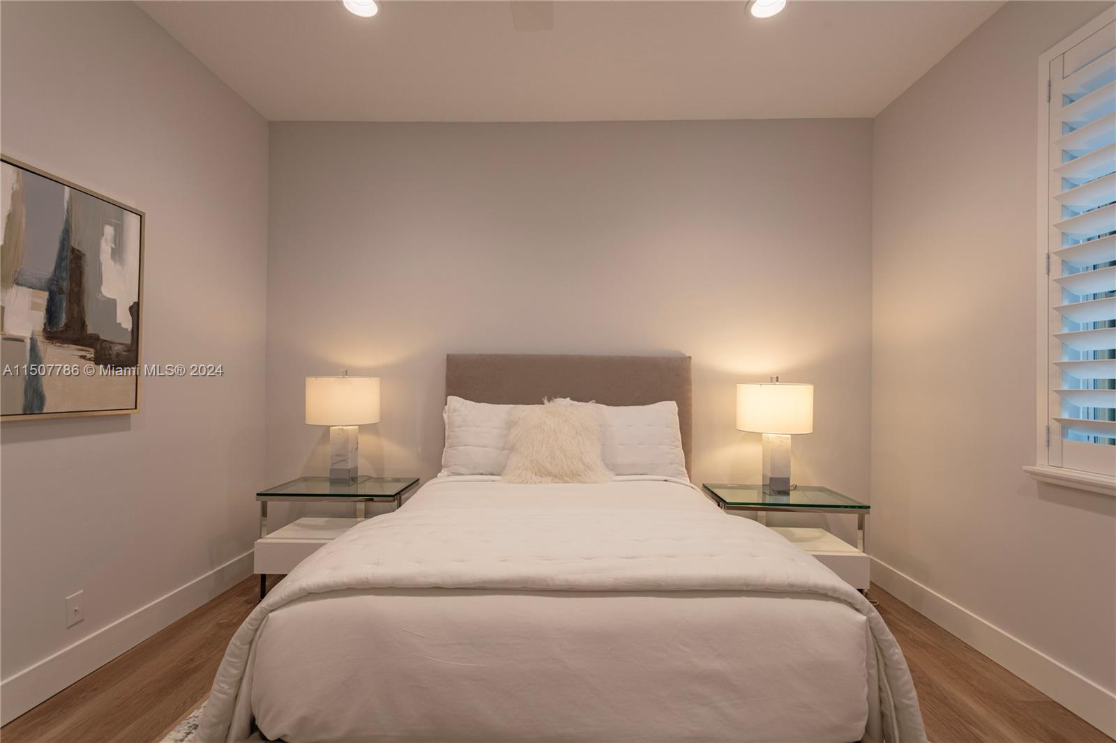 1655 Victoria Pointe Circle Weston, FL 33327 - Photo 38 of 43 a bedroom with a bed and a night stand