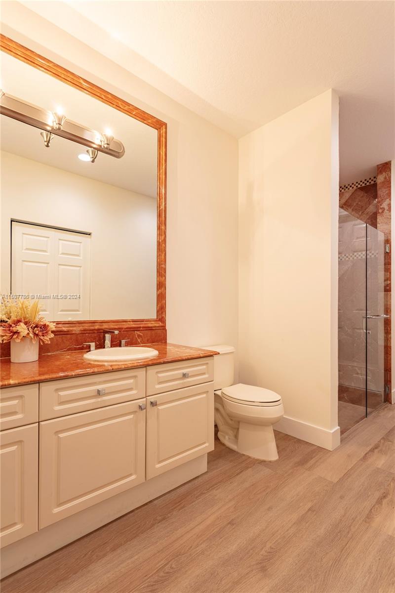 1655 Victoria Pointe Circle Weston, FL 33327 - Photo 41 of 43 a bathroom with a toilet a sink and a mirror