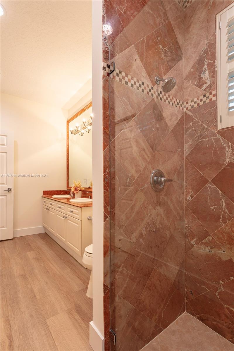 1655 Victoria Pointe Circle Weston, FL 33327 - Photo 42 of 43 a large bathroom with a double vanity sink a mirror and a shower