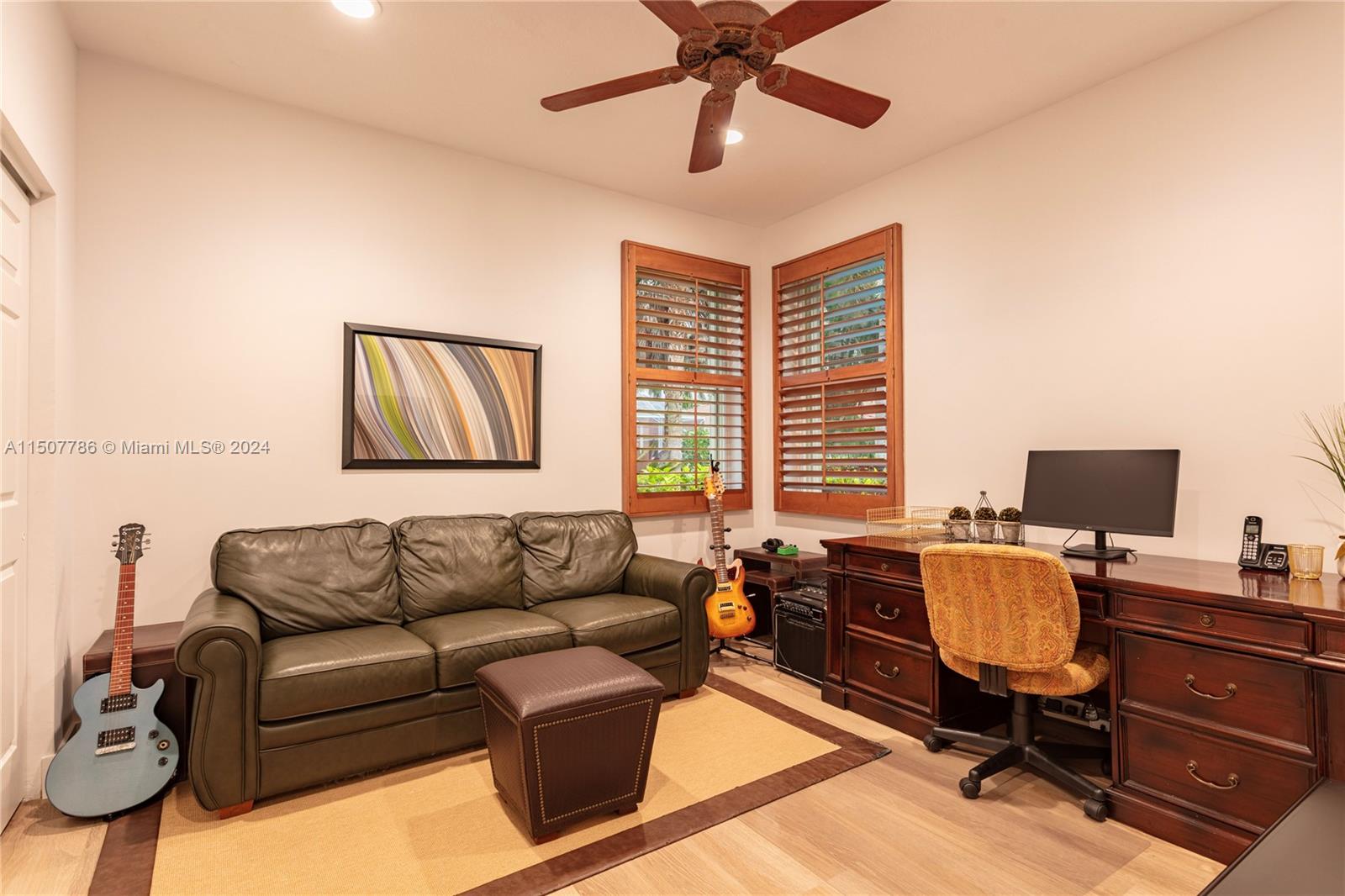 1655 Victoria Pointe Circle Weston, FL 33327 - Photo 43 of 43 a view of a livingroom with workspace and a couch