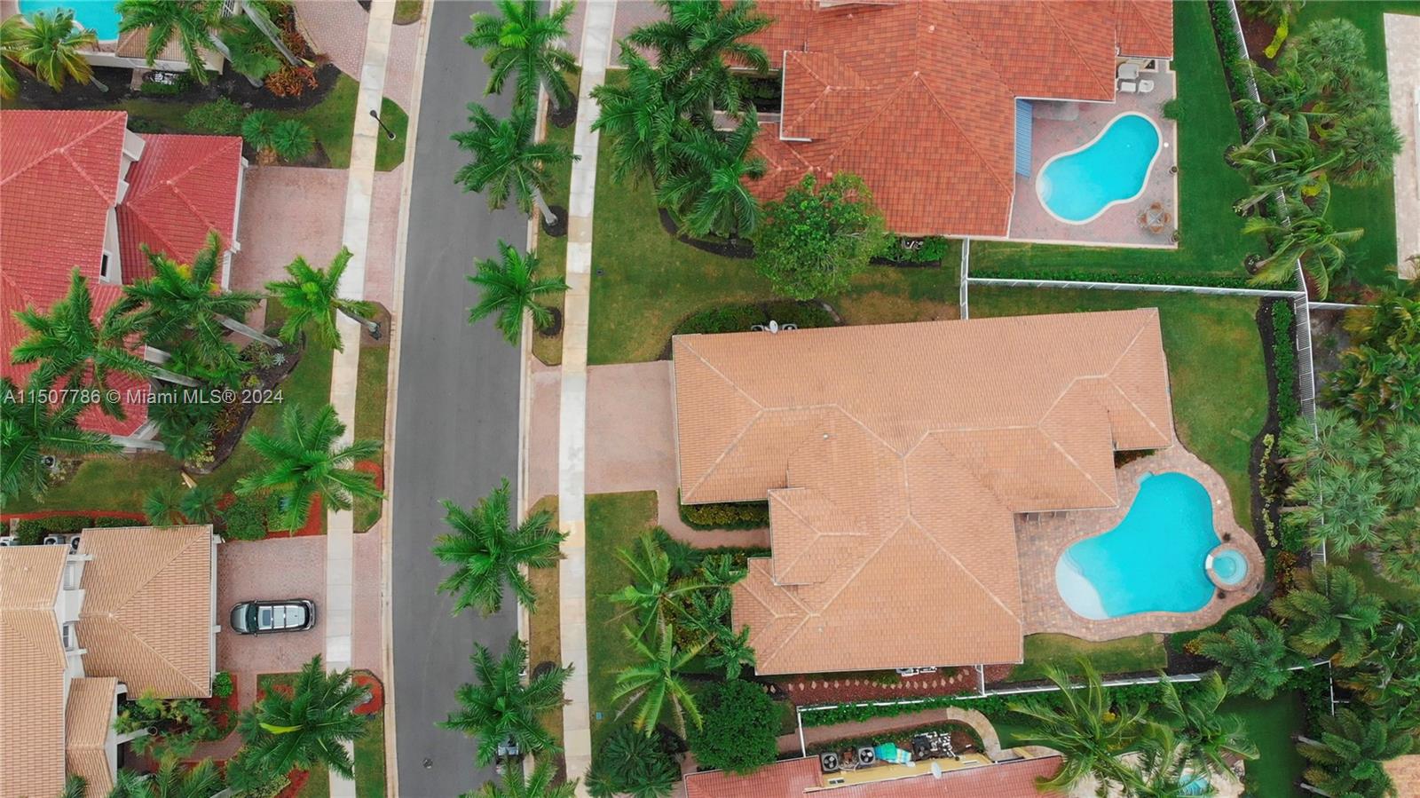 1655 Victoria Pointe Circle Weston, FL 33327 - Photo 6 of 43 an aerial view of a house with swimming pool and garden