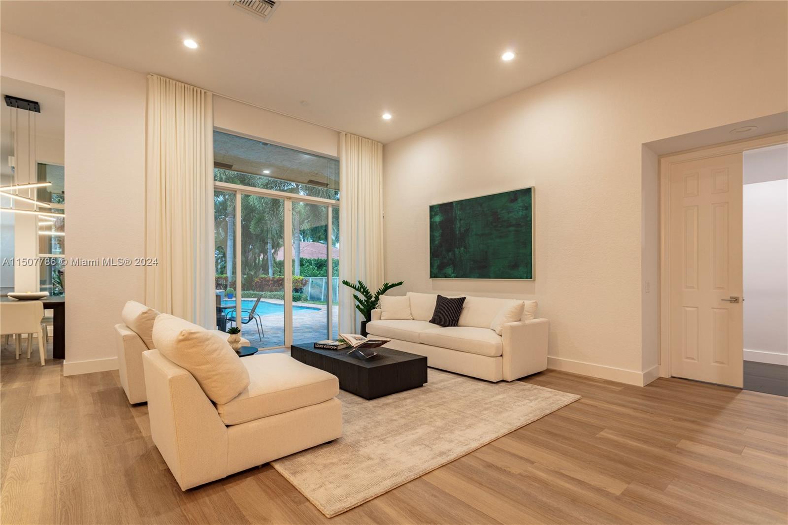 1655 Victoria Pointe Circle Weston, FL 33327 - Photo 10 of 43 a living room with furniture and a flat screen tv