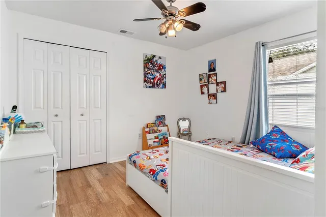 a bed room with a bed mirror and a window