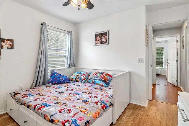 a bedroom with a bed and wooden floor