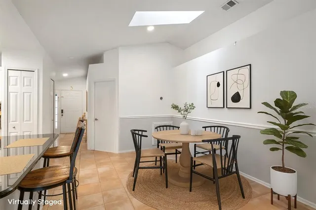 a view of a dining room with furniture and a potted plant