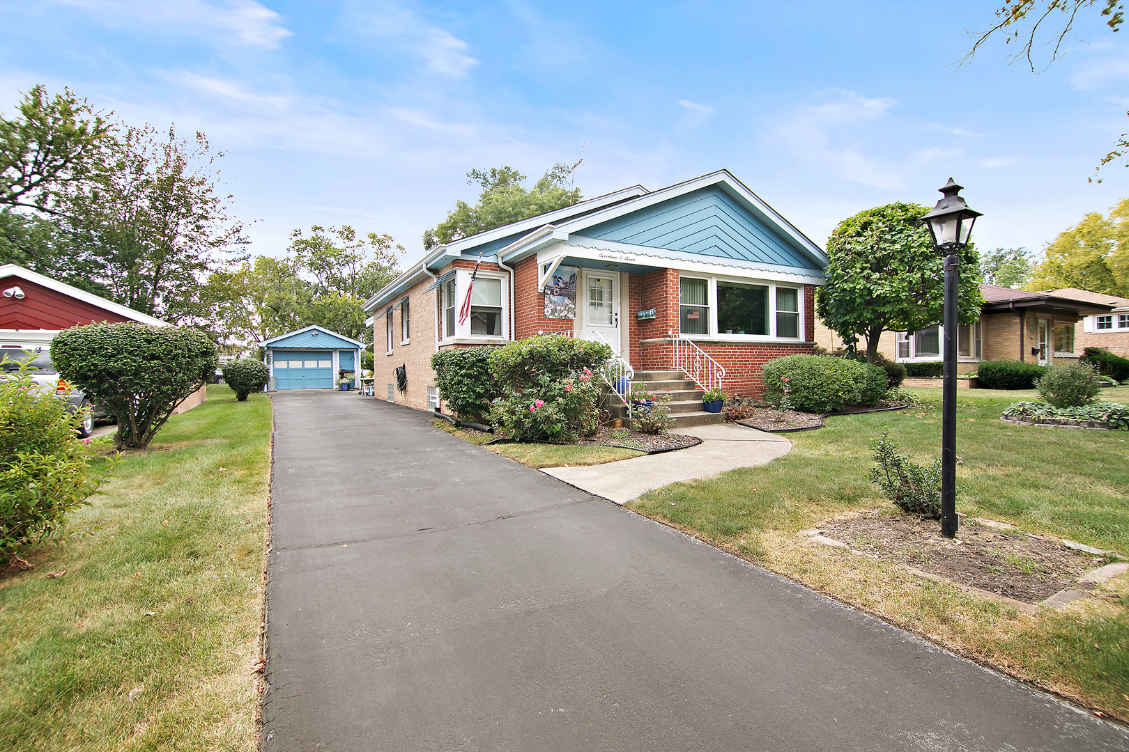 1707 Evergreen Road Homewood, IL 60430 - Photo 2 of 22 a front view of a house with garden
