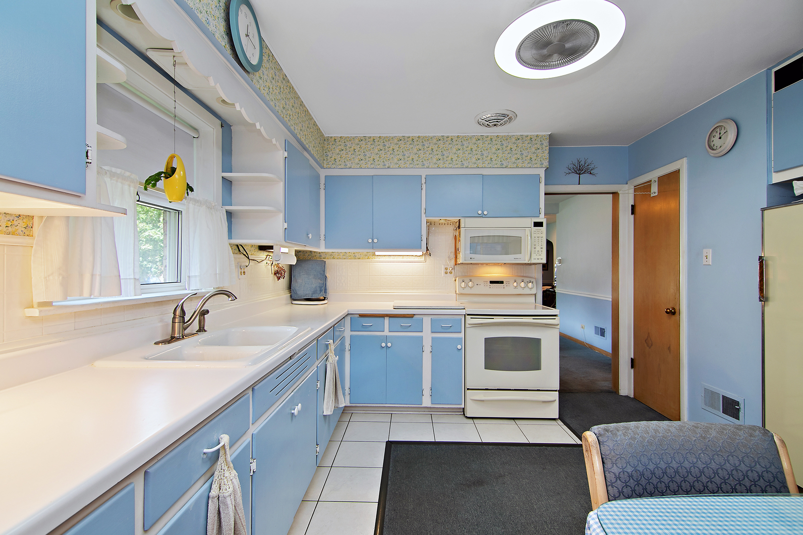 1707 Evergreen Road Homewood, IL 60430 - Photo 10 of 22 a kitchen with a sink a stove a refrigerator and a window