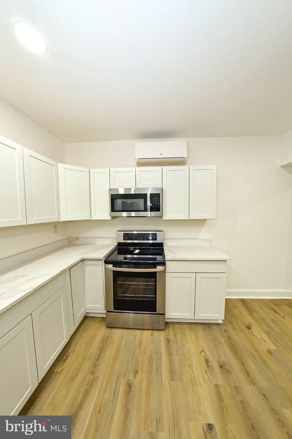 3704 Suitland Road Southeast Washington, DC 20020 - Photo 60 of 70 a kitchen with stainless steel appliances a stove a sink and white cabinets