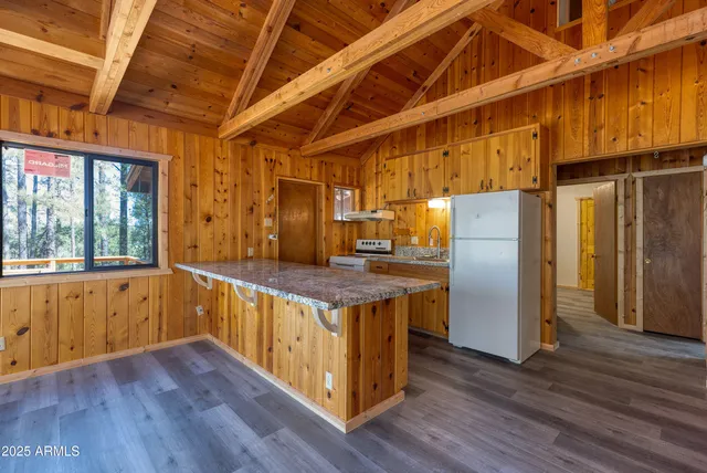 a kitchen with a wooden floor and a window