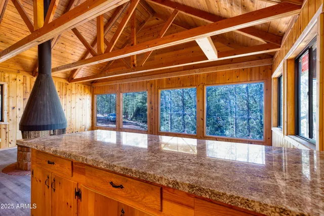 a view of a room with wooden floor and a tub
