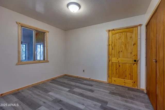 a view of an entryway with wooden floor