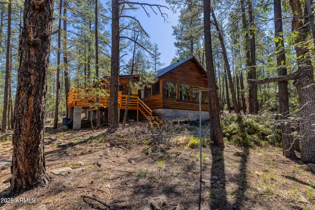 a view of a house with a small yard and sitting area