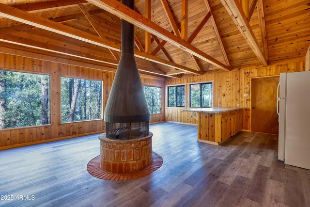 a living room with hard wood floors and a wooden floors