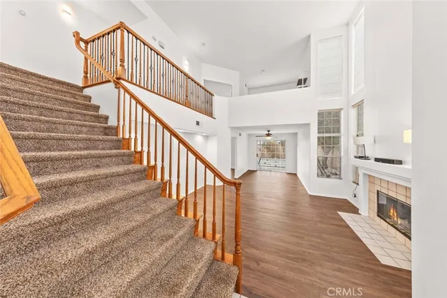 a view of a hallway with wooden floor and staircase