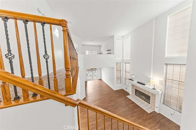 a kitchen with stainless steel appliances granite countertop a refrigerator a stove and white cabinets with wooden floor