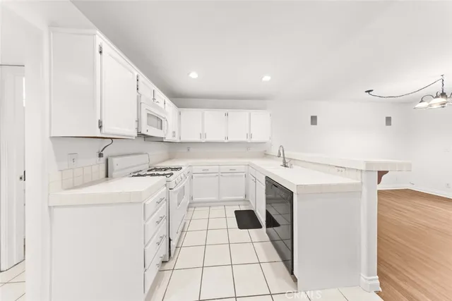 a kitchen with stainless steel appliances cabinets a sink and a stove