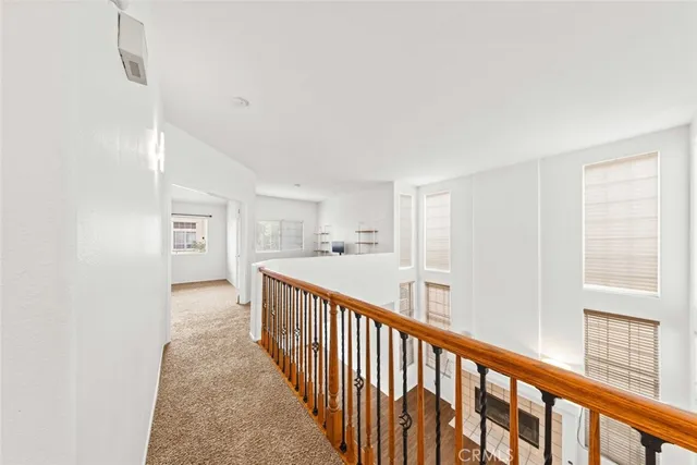 a view of a hallway with wooden floor and entryway