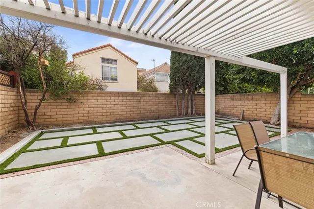 a view of backyard with a large space and a large tree
