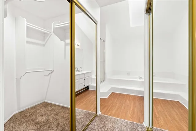 a bathroom with a tub sink and mirror