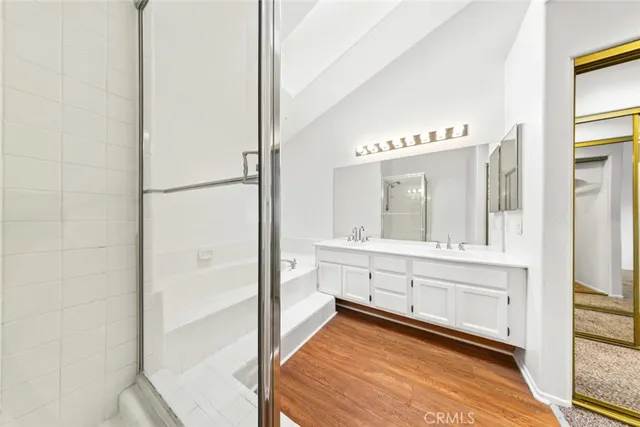 a view of a hallway with wooden floor and stairs