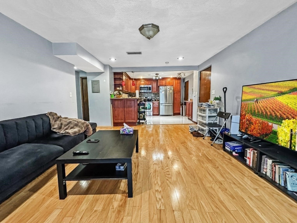 305 Riverside Avenue, Unit 24 Medford, MA 02155 - Photo 4 of 11 a living room with furniture and a flat screen tv
