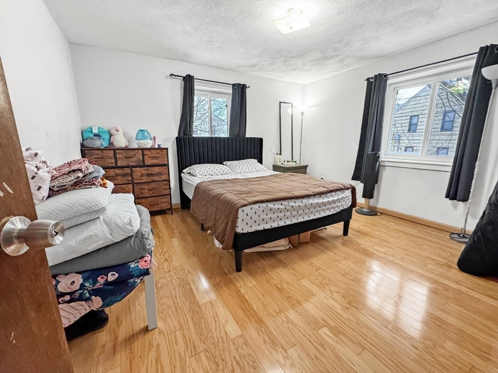 305 Riverside Avenue, Unit 24 Medford, MA 02155 - Photo 7 of 11 a bedroom with bed and window