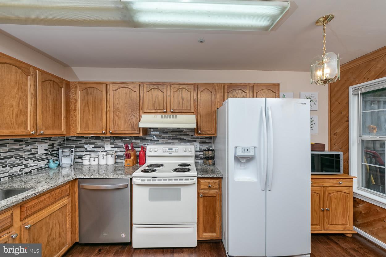 3504 Corn Stream Road Randallstown, MD 21133 - Photo 12 of 34 a kitchen with stainless steel appliances a refrigerator sink and cabinets