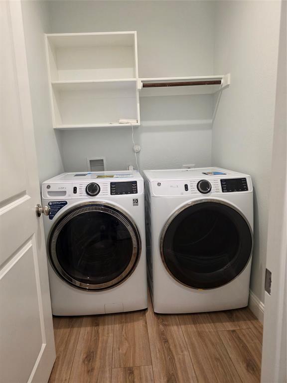 3209 Appleton Street Little Elm, TX 75068 - Photo 14 of 17 Laundry area with light wood-style floors and washer and clothes dryer