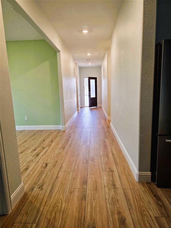 3209 Appleton Street Little Elm, TX 75068 - Photo 4 of 17 Corridor featuring light wood finished floors, a textured wall, and recessed lighting