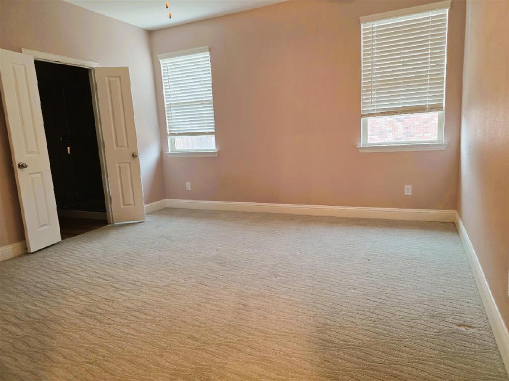 3209 Appleton Street Little Elm, TX 75068 - Photo 9 of 17 Unfurnished bedroom featuring light carpet and baseboards
