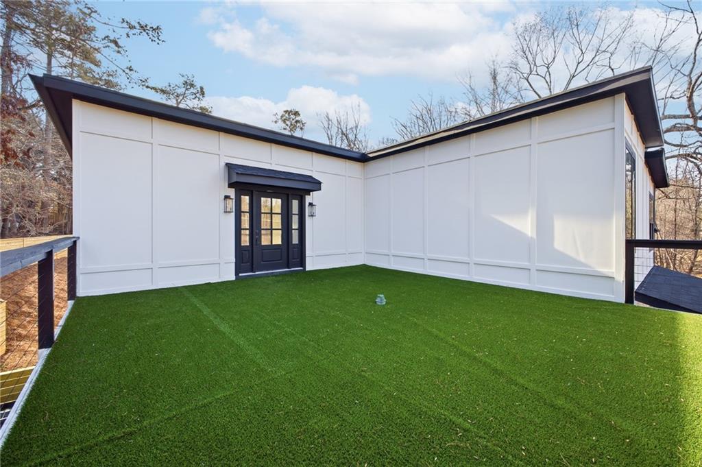 6465 Yacht Club Road Flowery Branch, GA 30542 - Photo 12 of 45 a backyard of a house with lots of green space