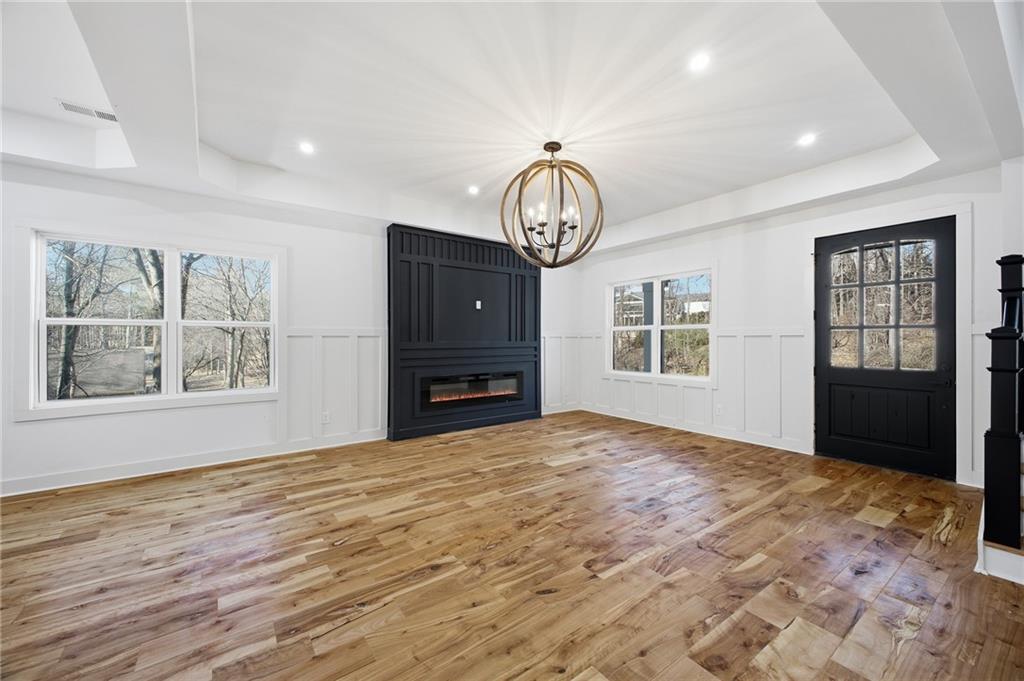6465 Yacht Club Road Flowery Branch, GA 30542 - Photo 15 of 45 a view of an empty room with window and wooden floor