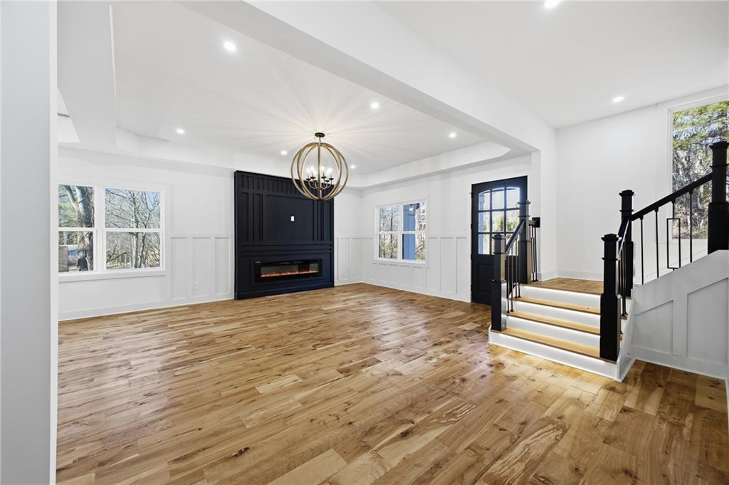 6465 Yacht Club Road Flowery Branch, GA 30542 - Photo 16 of 45 a view of empty room with wooden floor and window